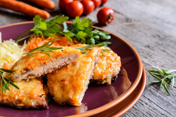 Wall Mural - Baked pork cutlets coated in cheese and carrot with salad