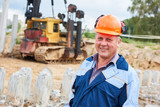 Fototapeta  - construction worker in front of pile driver machine