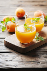 Healthy apricot juice with mint on the wooden table