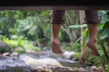 Wall Mural - Looking down on feet and a wooden surface, space for text. selective focus