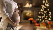 Pregnant Belly Girl Near The Christmas Tree. Background Blurry.