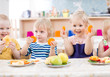 © Andrey Kuzmin - funny kids eating fruits in kindergarten dinning room