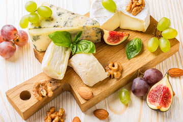 Wall Mural - Cheese platter with figs, grapes and nuts