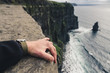 © mdurinik - holding tight at the edge of a cliff