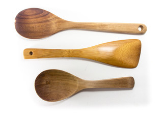 Kitchen equipment : ladle and kitchen flipper made form wood. Isolate on a white background.