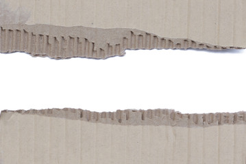 two scraps of torn corrugated cardboard