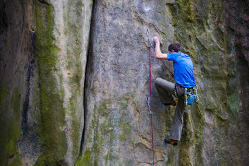 A rock climber climbs up the mountain.