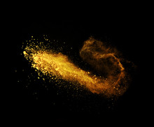 Explosion Of Yellow Powder On Black Background