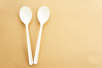 Twin spoons on brown background ,White spoon, The device is one of the cooking container. in eating