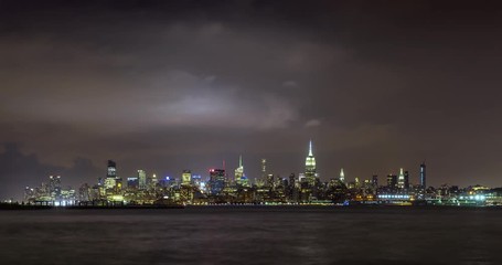 Wall Mural - Cityscape time lapse of a summer evening storm and lightning in New York City. View of Manhattan Midtown West skyscrapers, West Village and Hudson River