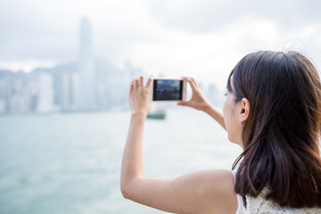 Canvas Print - Woman using mobile phone to take photo