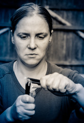 The woman holds in both hands broken pencils. Pencils are broken into two parts.
