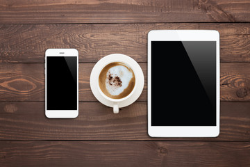 Poster - white phone tablet and coffee cup on wood table top view
