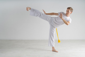 Man in sportswear performing a kick.