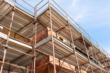 House for renovation with the scaffolding for bricklayers