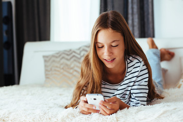 Poster - Girl with smartphone on sofa