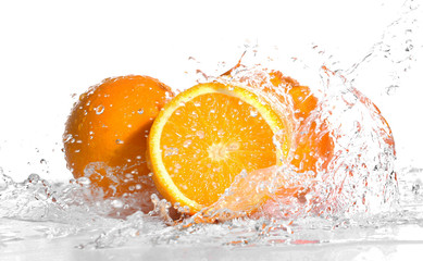 Wall Mural - Fresh oranges in splashing water isolated on white