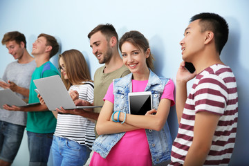 Wall Mural - Young people with gadgets hanging out together