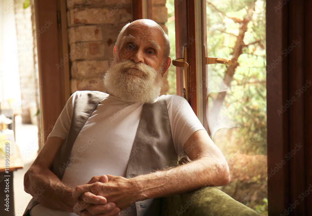Elderly man sitting by the window