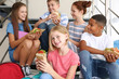 © Africa Studio - Schoolchildren eating sandwiches while sitting on stair-steps at school