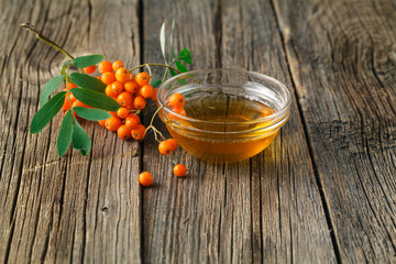 Wall Mural - rowan berries on wooden table