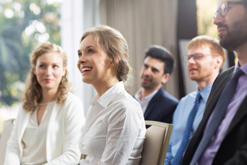 smiling audience watching presentation