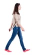 © ghoststone - back view of walking  woman in jeans . beautiful brunette girl in motion.  backside view of person.  Rear view people collection. Isolated over white background. The girl in a striped T-shirt with