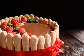 Wall Mural - Delicious birthday cake with walnuts filling and strawberries, blueberries and savoiardi biscuit decoration