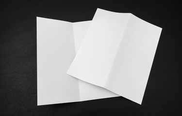 Bifold white template paper on black background .