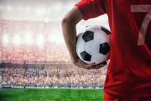 Soccer Football Player In Red Team Concept Holding Soccer Ball In The Stadium