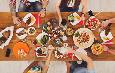 Wall Mural - People eat meals drink alcohol at festive table dinner party