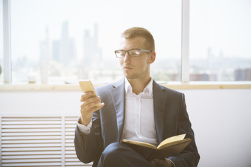 Wall Mural - Man with notepad using smartphone