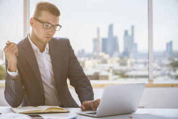 Wall Mural - Handsome businessman working on project