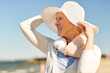 © Syda Productions - happy senior woman in sun hat on summer beach