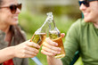 © Syda Productions - close up of happy couple clinking drinks outdoors