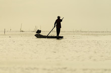 Silhouettes Of The Traditional Stilt Fishermen At Sunset 