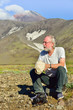 Rest of the researcher/Photo-portrait of a researcher and a volcanologist at the background of the volcano Avacha