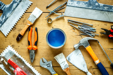 construction tools on a wooden table with blue paint