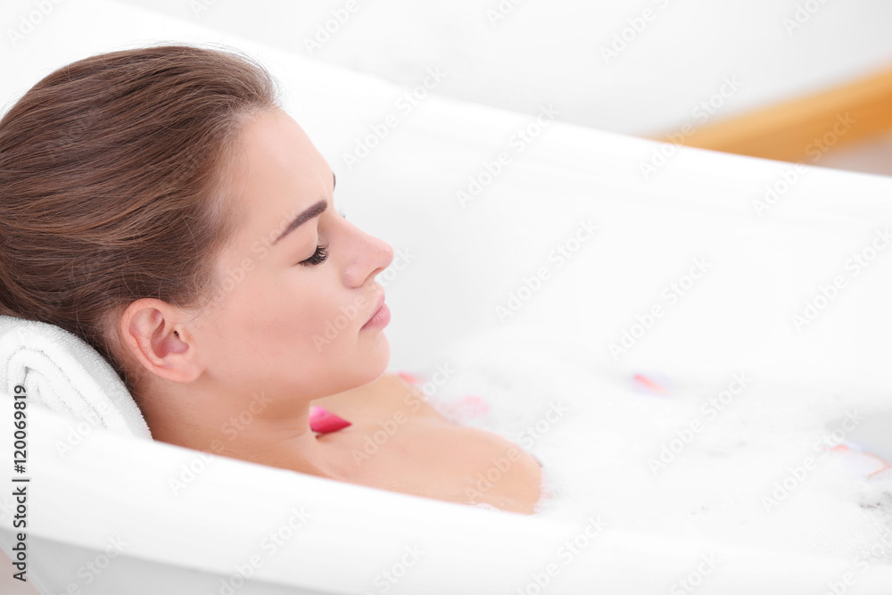 Beautiful girl relaxing in bathtub