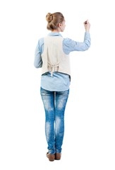 Wall Mural - back view of writing beautiful woman. Young girl in jeans draws. Rear view people collection.  backside view of person. Isolated over white background. Girl in sleeveless felt-tip pen draws on the