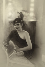 Beautiful Flapper Girl With Wineglass. Old Photo In A Retro Style. Smoky Eyes, Hairstyle Cold Wave. Creative Colors