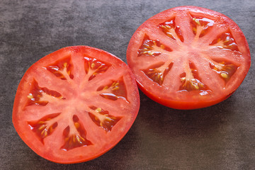 Close-up of tomatoes on a black background.