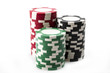 Three stacks of red, green and black casino chips isolated on white