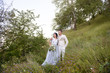 © ronedya - Young couple in love outdoor. Elegant bride and groom posing together outdoors on a wedding day. bride and groom in the Park. young couple in the woods. young couple in the grass. couple walking