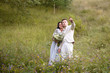 © ronedya - Young couple in love outdoor. Elegant bride and groom posing together outdoors on a wedding day. bride and groom in the Park. young couple in the woods. young couple in the grass. couple walking