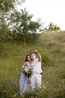 © ronedya - Young couple in love outdoor. Elegant bride and groom posing together outdoors on a wedding day. bride and groom in the Park. young couple in the woods. young couple in the grass. couple walking