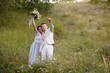 © ronedya - Young couple in love outdoor. Elegant bride and groom posing together outdoors on a wedding day. bride and groom in the Park. young couple in the woods. young couple in the grass. couple walking