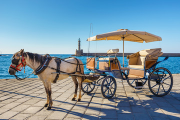 Wall Mural - Horse carriage for transporting tourists in old port of Chania on Crete, Greece