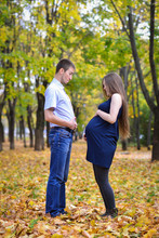 Future Parents, Young Man And Pregnant Women Having Fun In Autumn Park