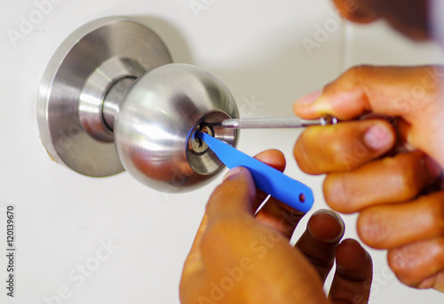 Closeup Hands Of Locksmith Using Pick Tools To Open Locked